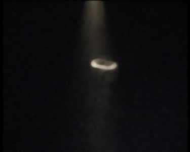 smoke ring rising in a beam of light